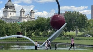 Double Decker Family walking past the cherry on a spoon sculpture at the Minneapolis Sculpture Garden.